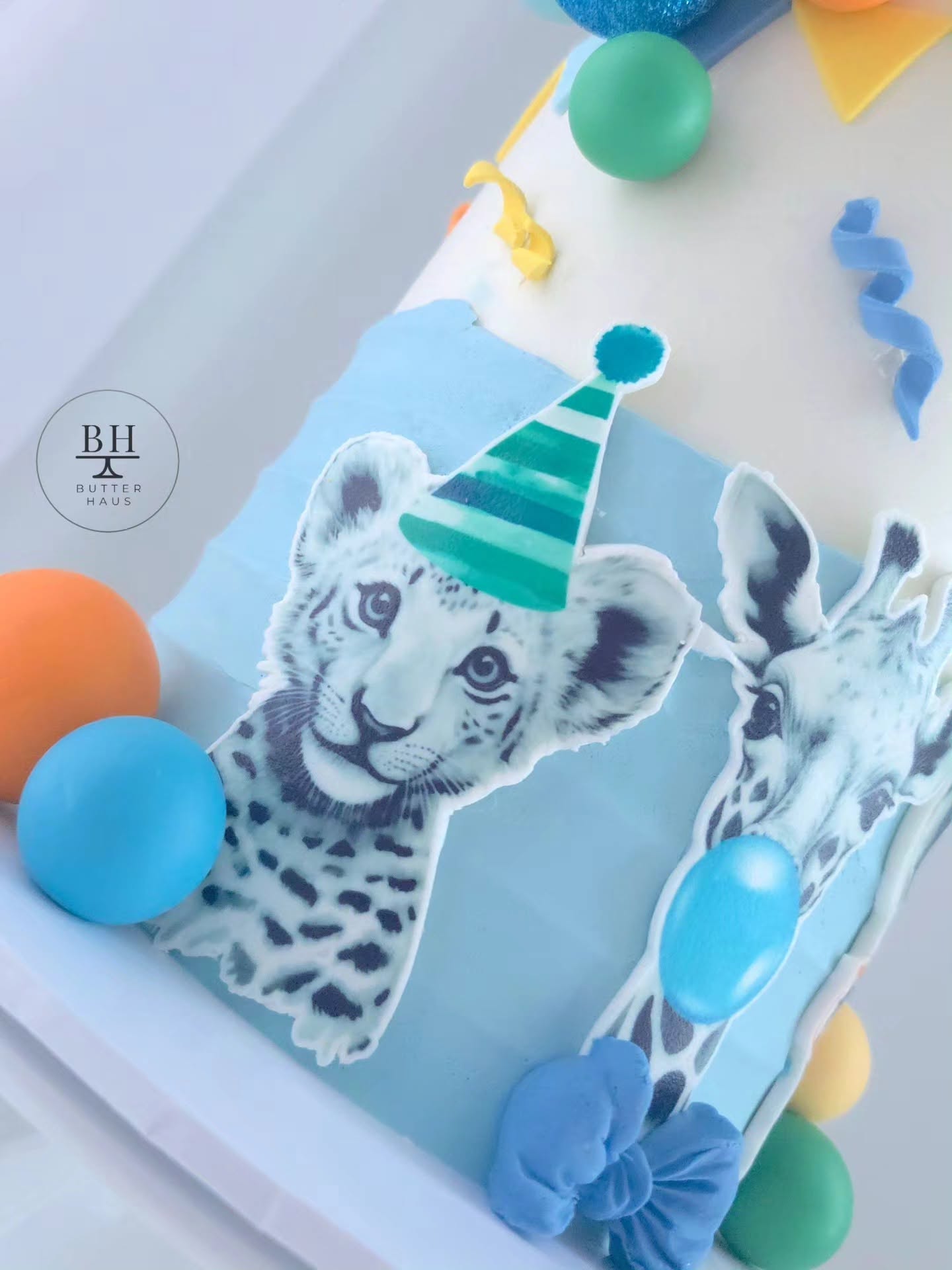 Party Animals cake with sunglasses-clad zebra cutout and custom age topper