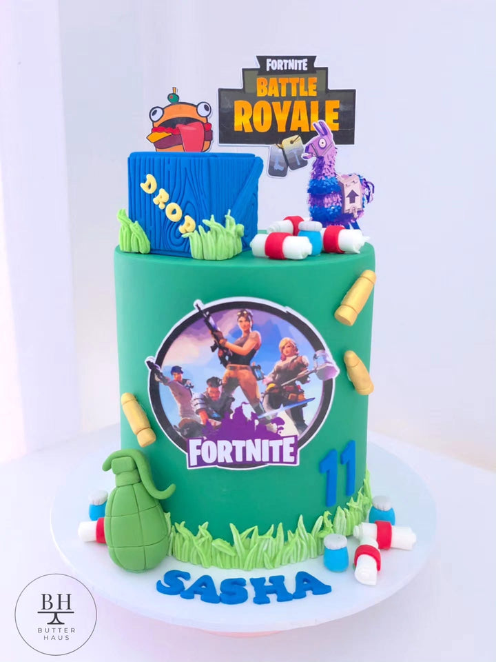 Green Fortnite inspired birthday cake with blue supply crate, llama topper and gamer details