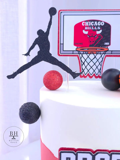 Close-up of the custom name and age topper on the basketball birthday cake