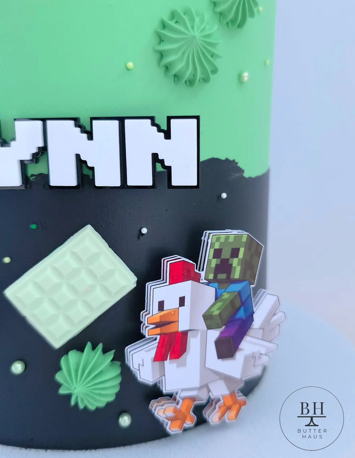 Side view of Minecraft Adventure cake with white chocolate block pieces
