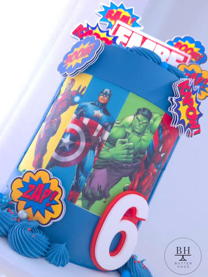 Avengers themed birthday cake with custom name and age topper, featuring Iron Man, Captain America, Thor and Spider-Man cardstock images