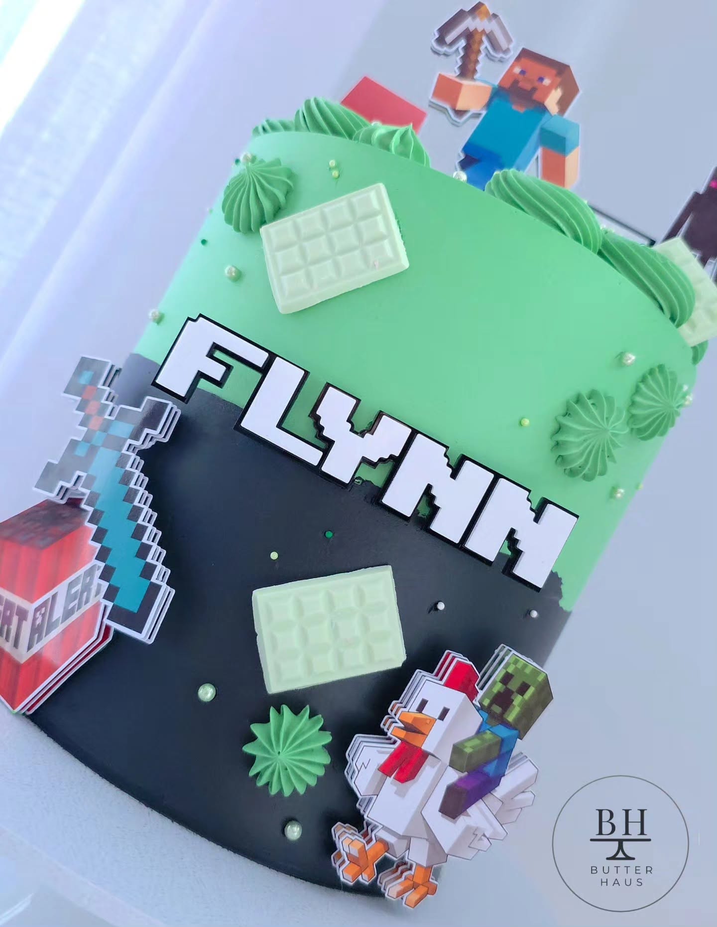 Close-up of diamond sword and TNT block toppers on Minecraft Adventure cake