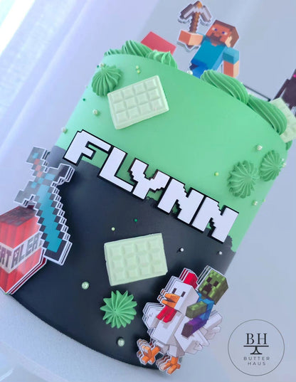Close-up of diamond sword and TNT block toppers on Minecraft Adventure cake