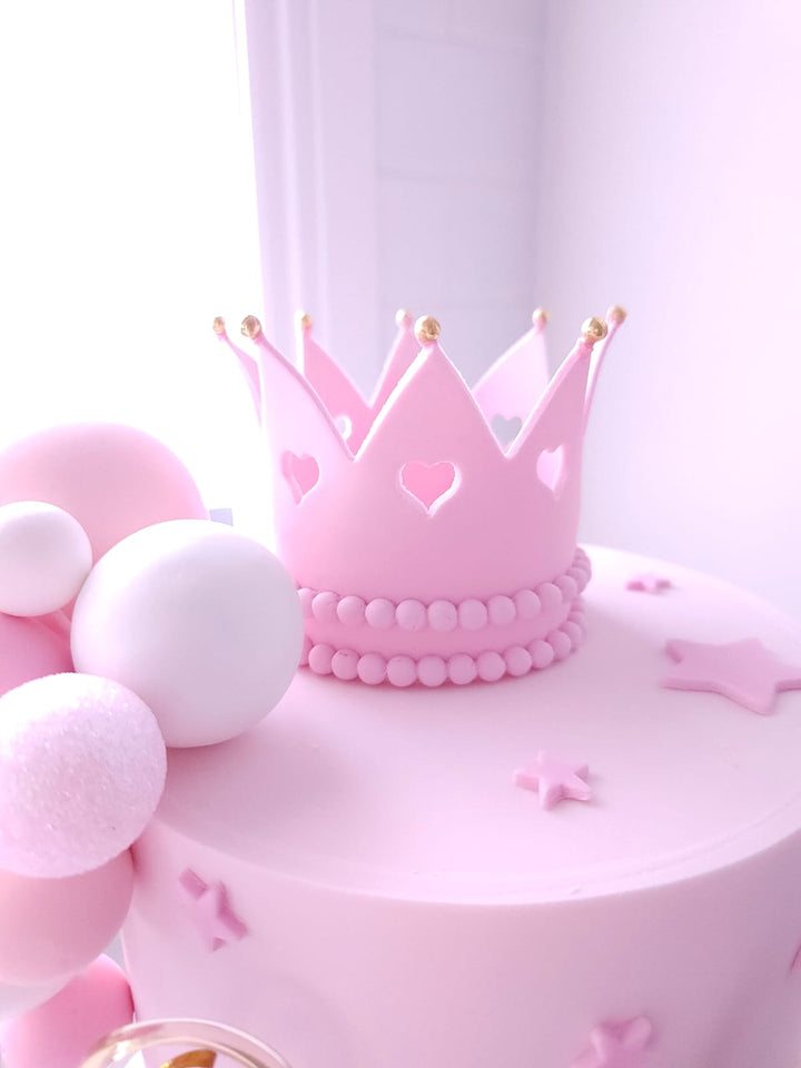 Close-up of handmade fondant crown and bow on Once Upon A Bow cake