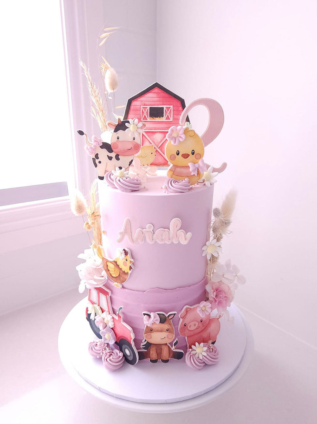 Little Farm Friends birthday cake with pastel buttercream, dried florals and cardstock farm animals