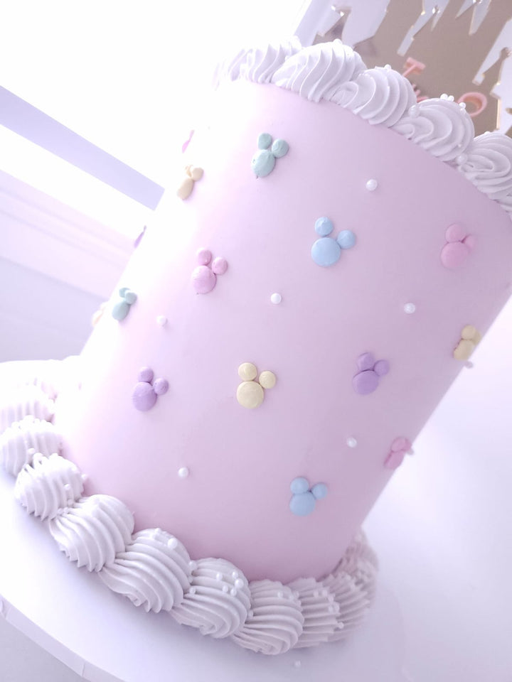 Close-up of piped buttercream border and castle topper on Once Upon a Castle cake