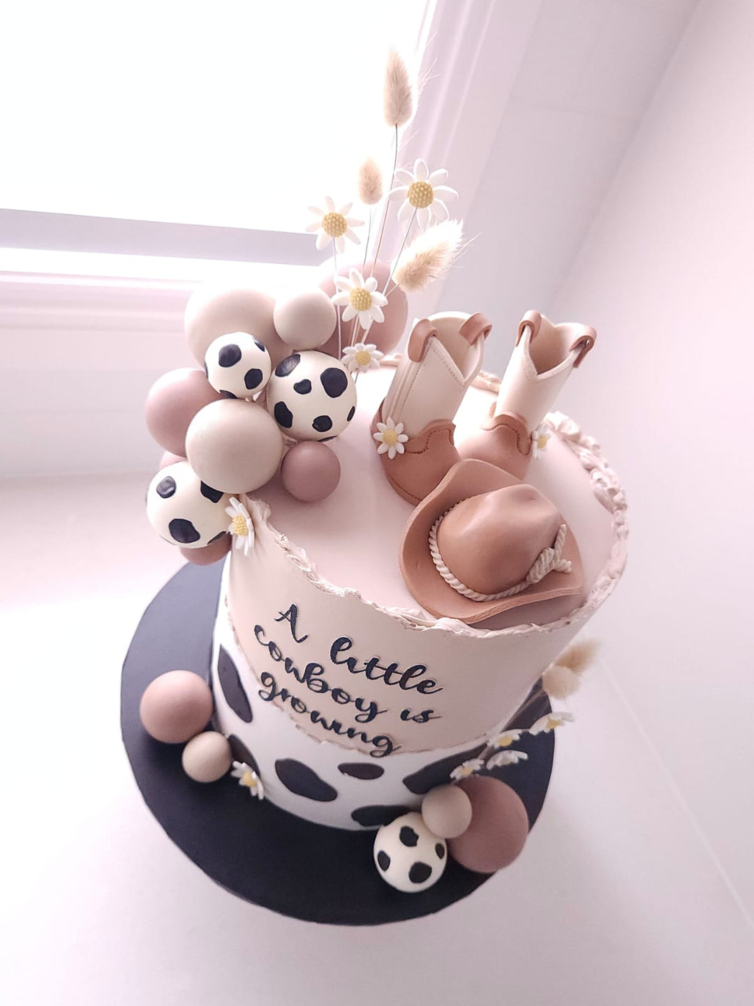 Little Rodeo cake styled in soft neutral western tones