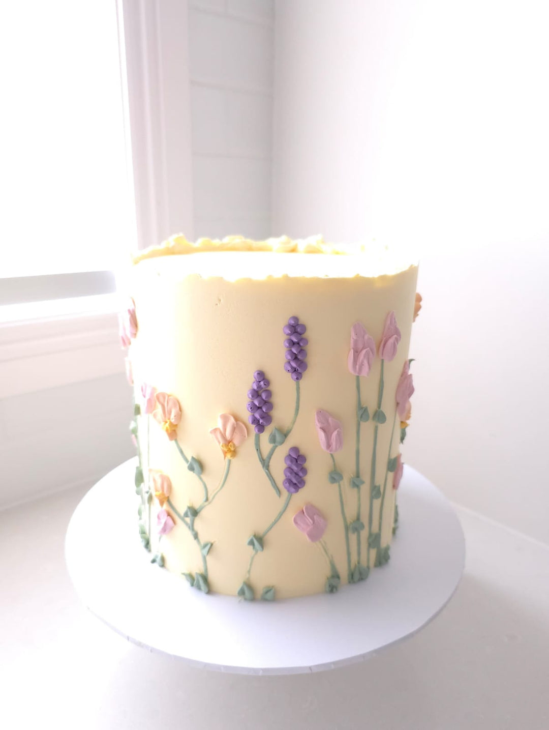 Floral Bloom smooth buttercream birthday cake with hand-piped florals and flowing stems