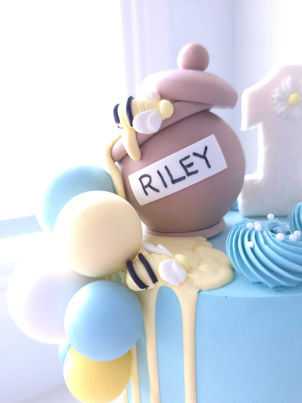 Close-up of fondant bees and honey style drip on Sweet As Can Bee cake