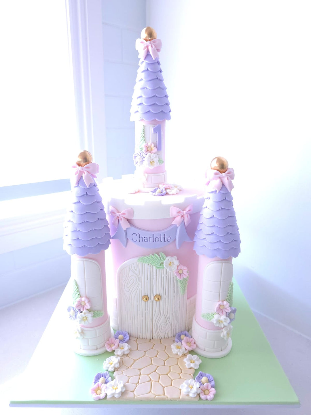 Princess Party Palace pastel castle birthday cake with elegant towers, fondant bows and floral details