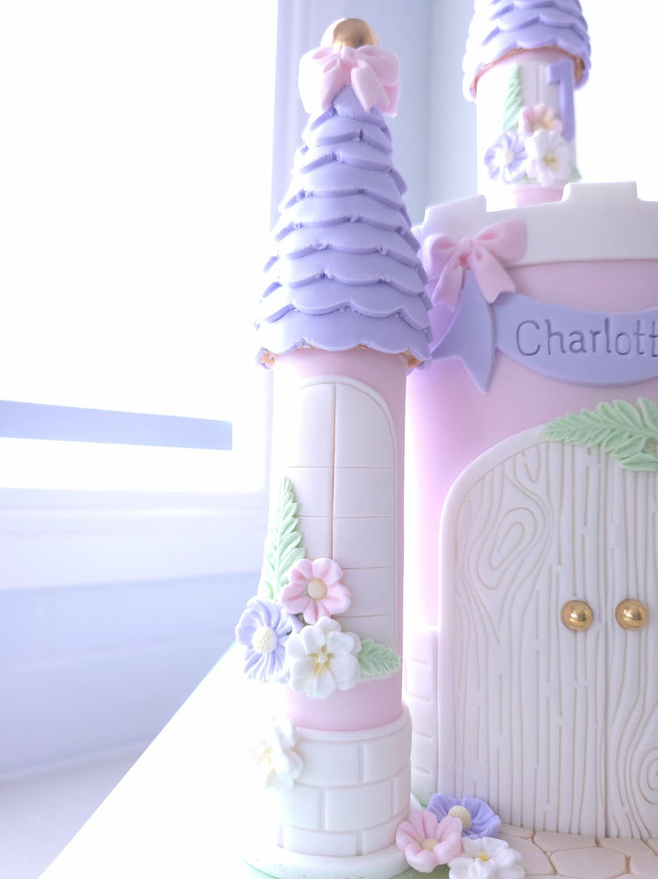 Close-up of arched doors and petal-lined pathway on Princess Party Palace cake