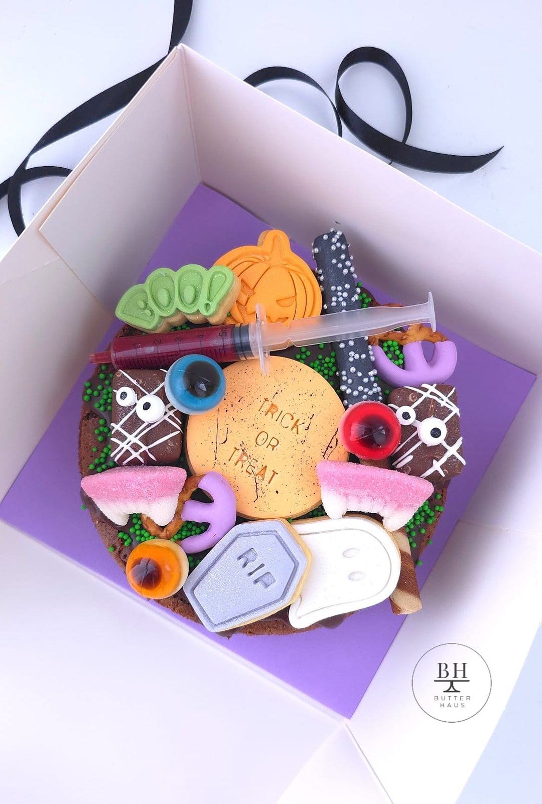 Halloween brownie by Butter Haus, 6 inch round chocolate brownie topped with iced Halloween cookies in a gift box